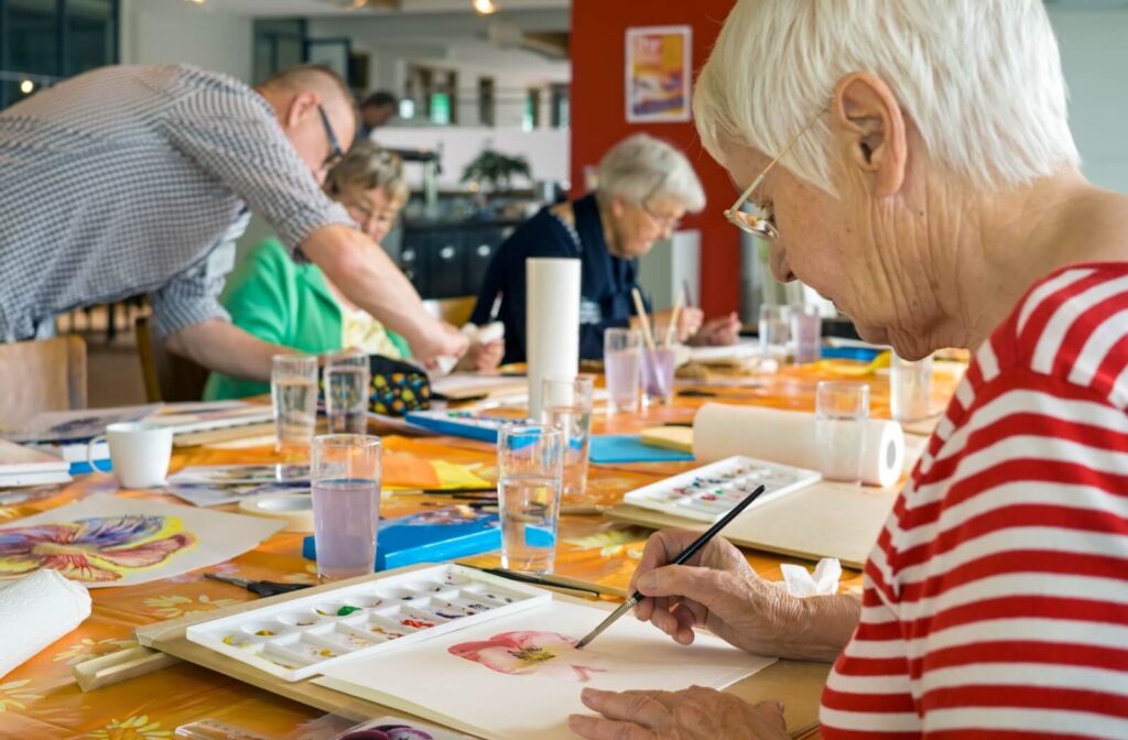 A group of older adults painting with watercolors.